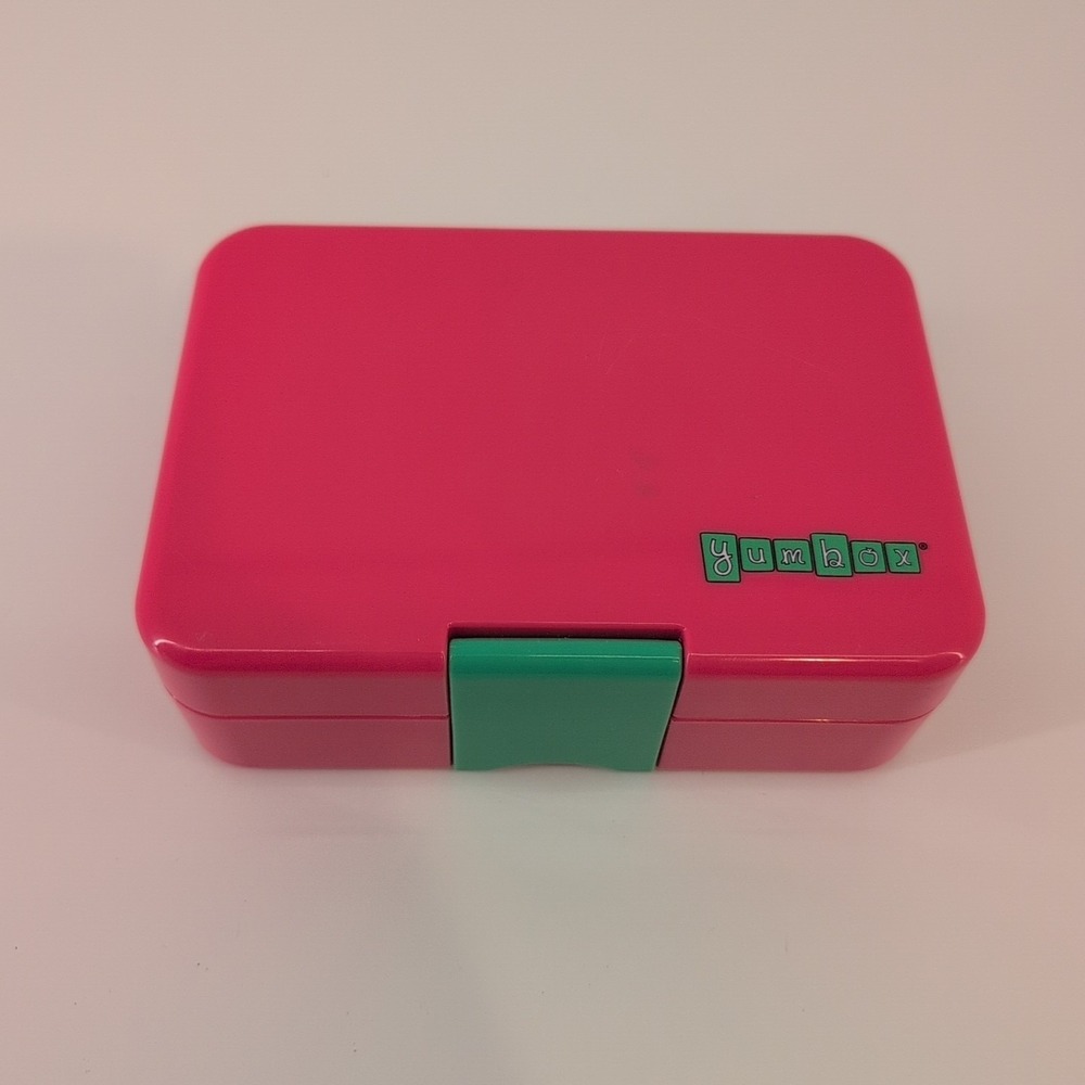 Yumbox Mini Snack bento lunch box in pink with a green latch